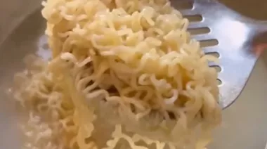 Creamy butter garlic cheesy noodles topped with cheese and spring onions